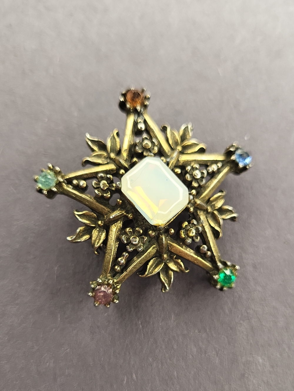 Vintage-Inspired Gold Starburst Brooch with Opalescent Center